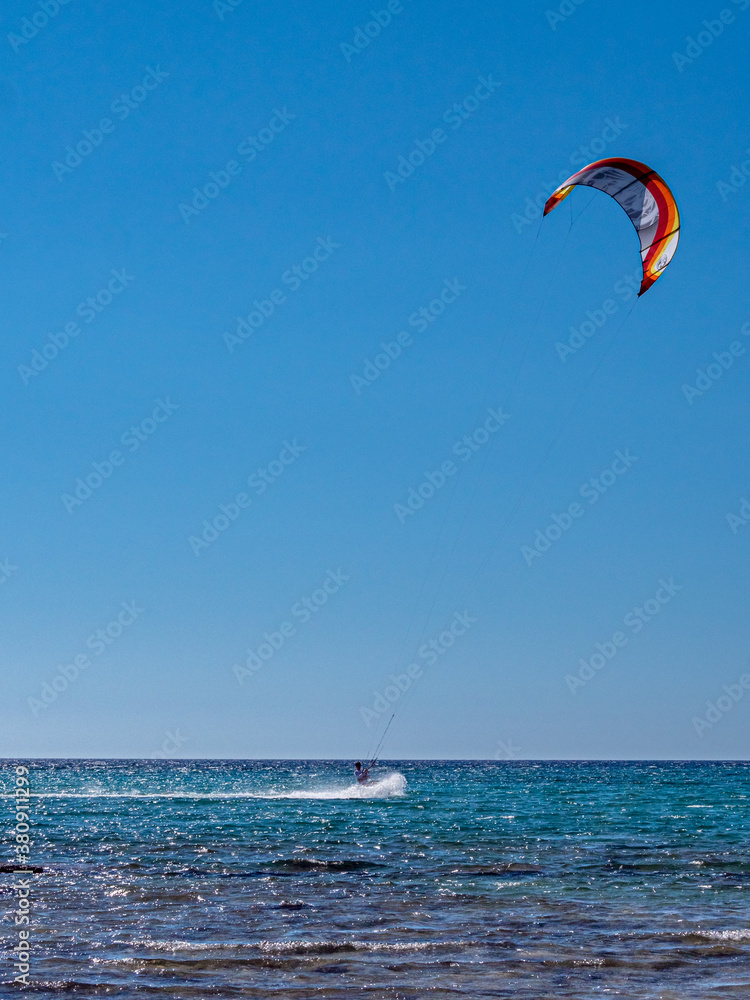 Kite Surfing through the afternoon sun with silhouette contours Kite Surfing through the afternoon sun with silhouette contours