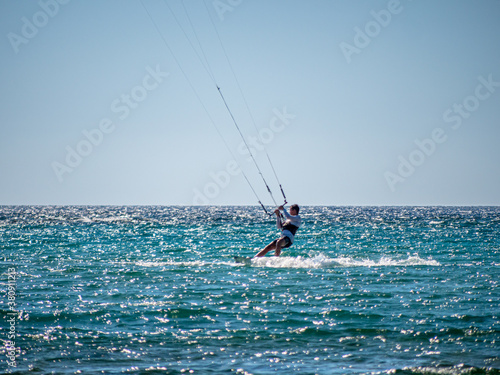 Kite Surfing through the afternoon sun with silhouette contours