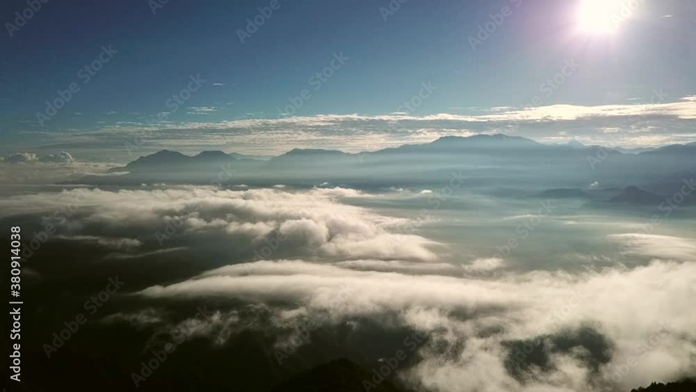 Looking out over the Alishan Mountain ridges in Taiwan with dramatic clouds and sunlight. Looking out over the Alishan Mountain ridges in Taiwan with dramatic clouds and sunlight.