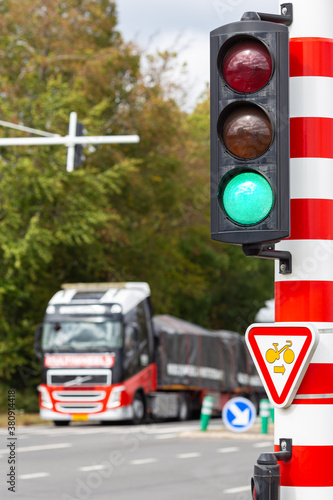 Truck passing a road intersection at a green light of a traffic signal