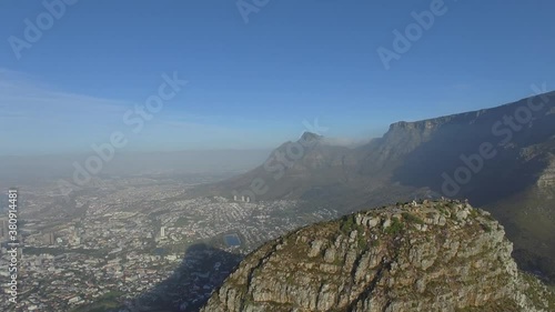 Rotating view from the air, above Lions Head, showing the city, the ocean and Table Mountain during Sunset