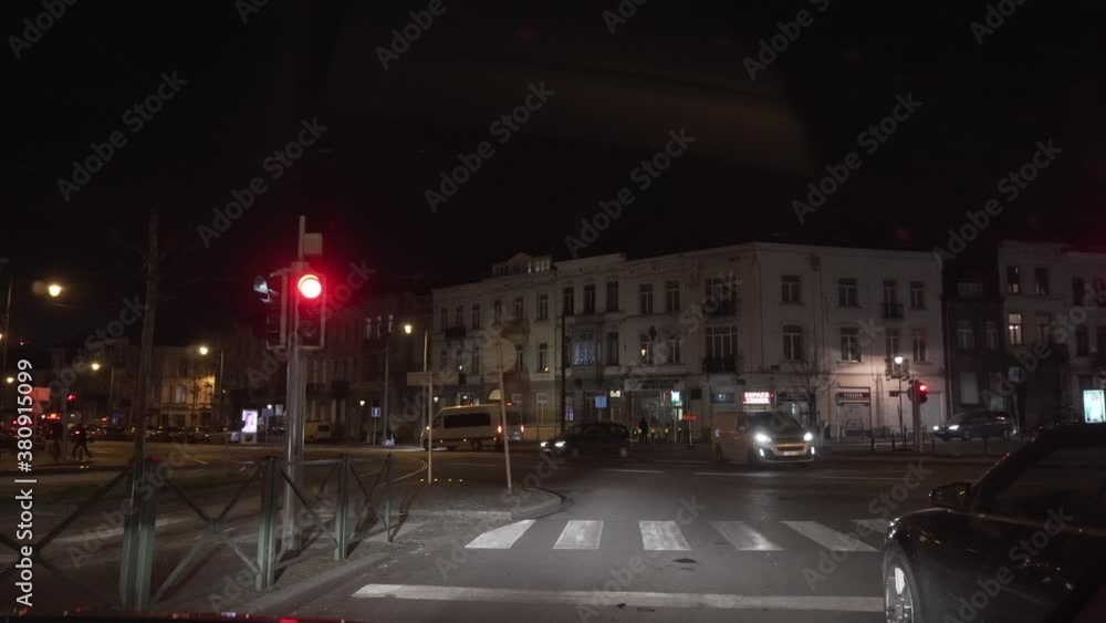 Red traffic light with a car passing in the road. Red traffic light with a car passing in the road.