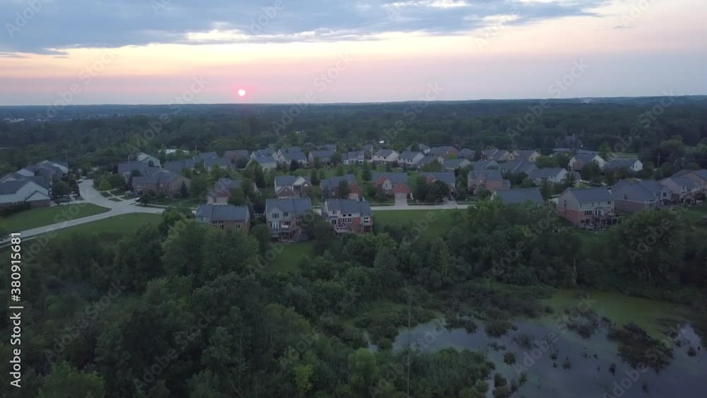 Pulling back drone shot of a residential area at sunset Pulling back drone shot of a residential area at sunset