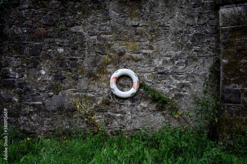 Life Buoy on Ancient Stone Wall, Ireland photo