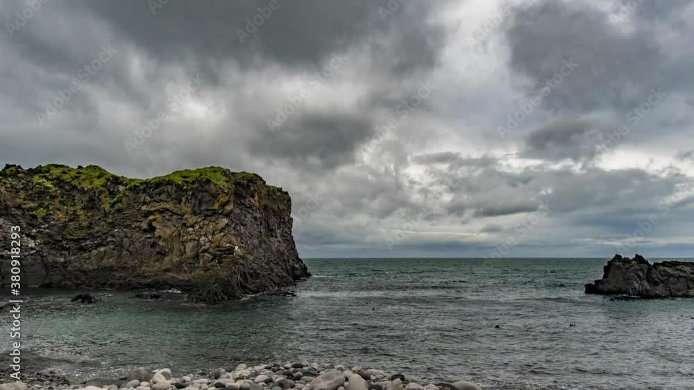 Clouds moving over the ocean behind the rocky features of Hellnar Iceland. Clouds moving over the ocean behind the rocky features of Hellnar Iceland.