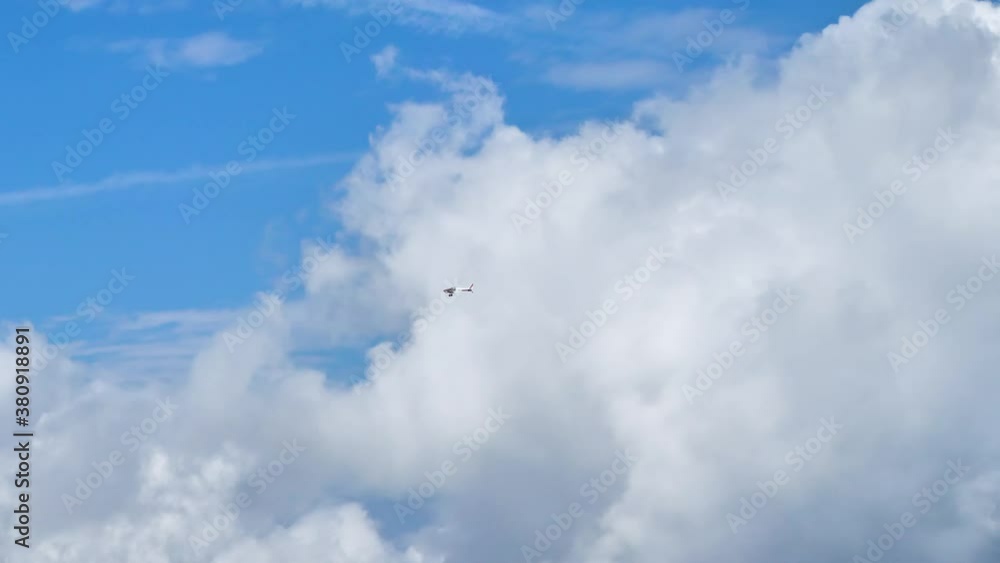 Light aircraft/ plane pans above large clouds Light aircraft/ plane pans above large clouds