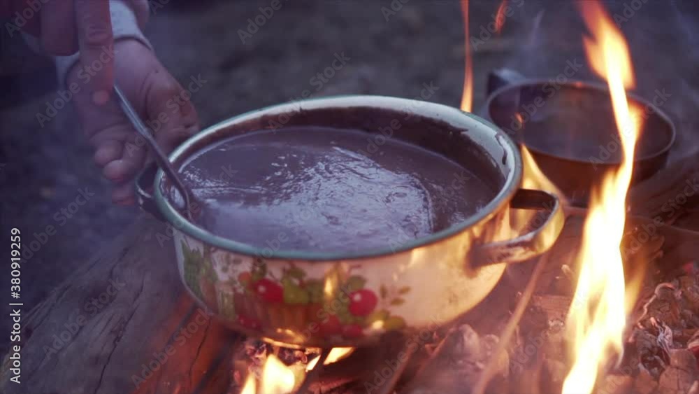 Slow motion of a spoon stirring bean stew as preparations for dinner are underway. Slow motion of a spoon stirring bean stew as preparations for dinner are underway.