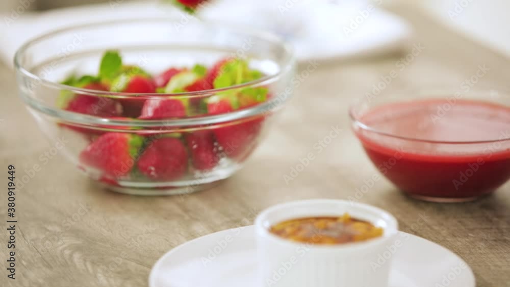 Picking Up Ramekin and Putting on Plate with Strawberries Picking Up Ramekin and Putting on Plate with Strawberries