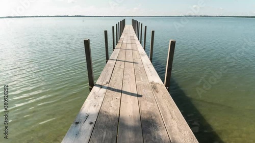 Time lapse of shadows on dock. This time lapse was shot in Okoboji, Iowa on West Lake. Great leading lines will draw your viewers in to this great landscape. photo