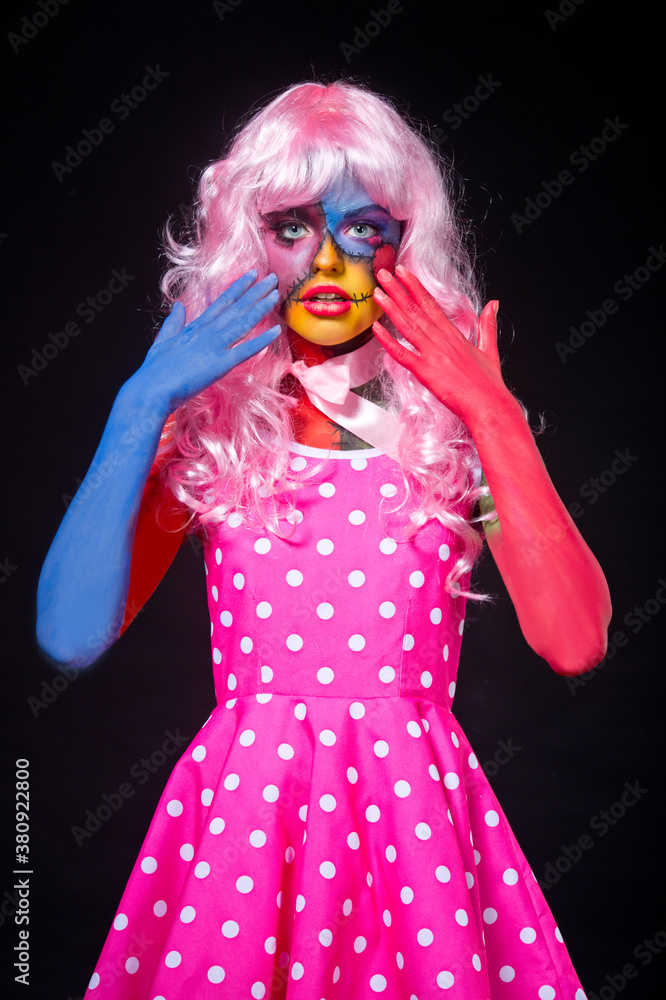 Girl in the suit and the image of a terrible dead doll with a sewn mouth. Halloween. Girl in the suit and the image of a terrible dead doll with a sewn mouth. Halloween.