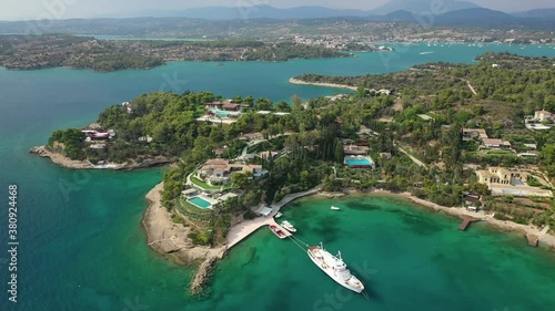 Aerial drone video of Hinitsa island bay a popular anchorage crystal clear turquoise sea bay for yachts and sailboats next to Porto Heli, Saronic gulf, Greece photo