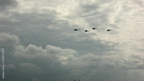 Close up of military helicopters flying above the Warsaw city photo