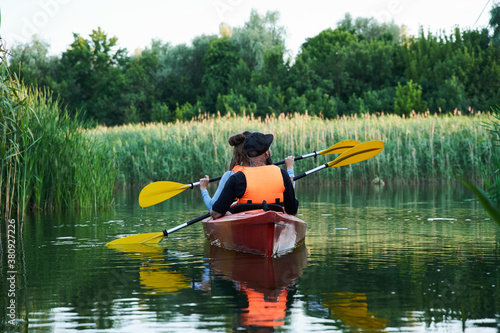 Couple Paddling Kayak on Lake