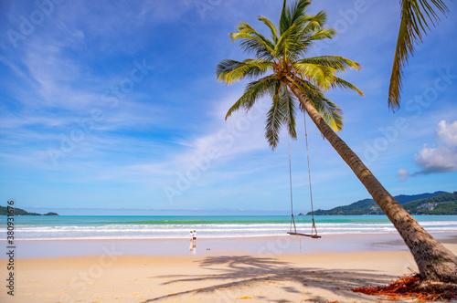 Fototapeta Naklejka Na Ścianę i Meble -  Summer beach with palms trees around in Patong beach Phuket island Thailand, Beautiful tropical beach with blue sky background in summer season.