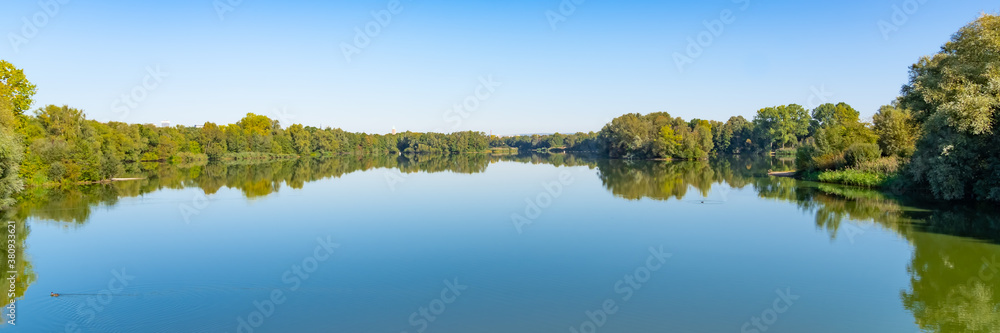 Beautiful panorama of the lake landscape on a summer day in the Fuldaaue in Kassel, Germany