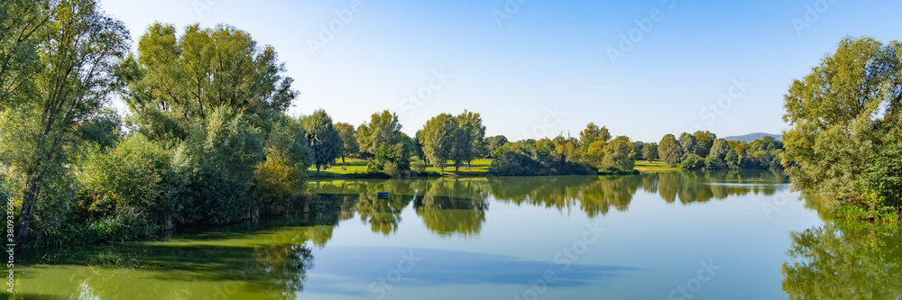 Beautiful panorama of the lake landscape on a summer day in the Fuldaaue in Kassel, Germany