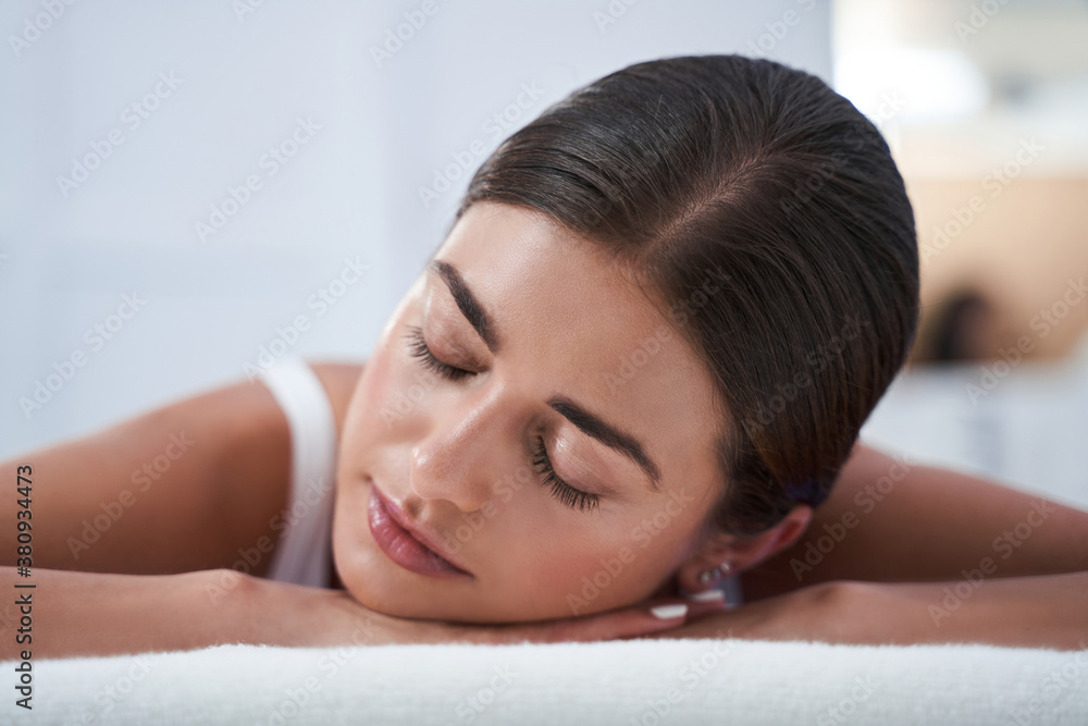 Woman enjoying back massage with closed eyes Woman enjoying back massage with closed eyes