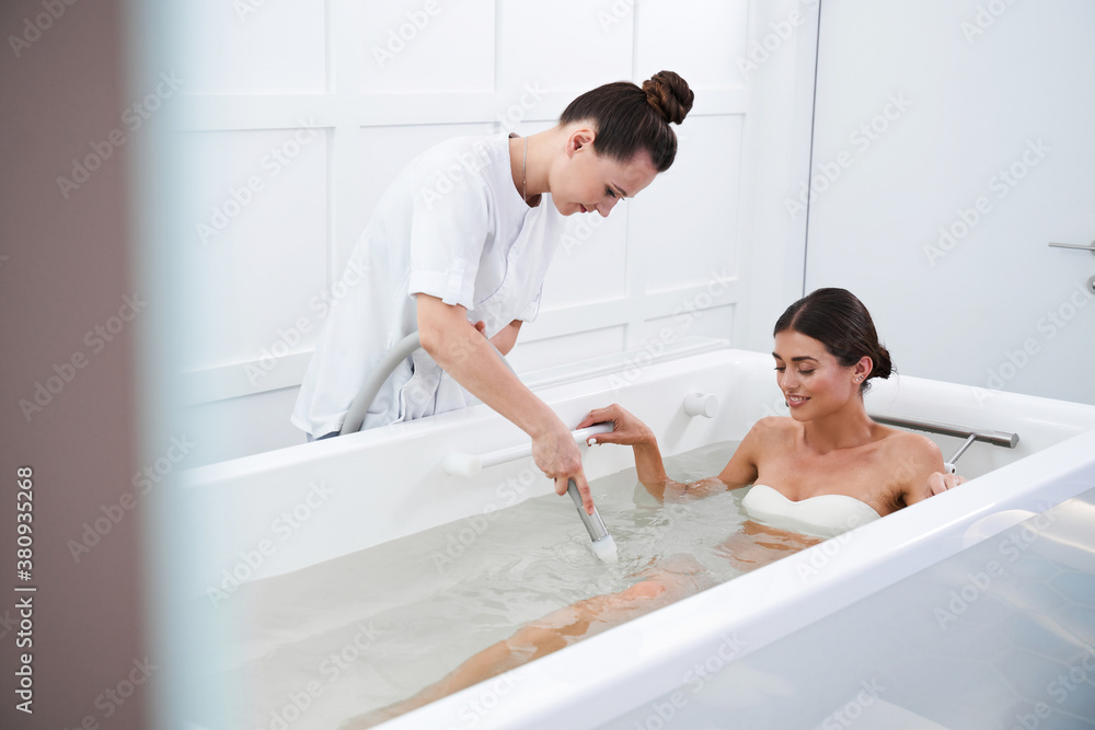 Girl swimming with pleasure in comfortable bath Girl swimming with pleasure in comfortable bath