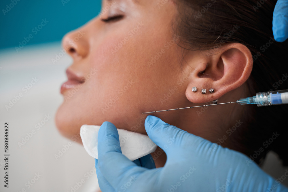 Injecting Botox Photo Woman receiving a botox injection Stock Photo | Adobe Stock