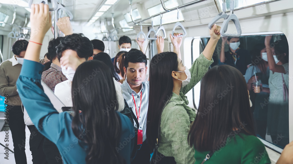 Crowd of people wearing face mask on a crowded public subway train travel . Coronavirus disease or COVID 19 pandemic outbreak and urban lifestyle problem in rush hour concept . - obrazy, fototapety, plakaty 