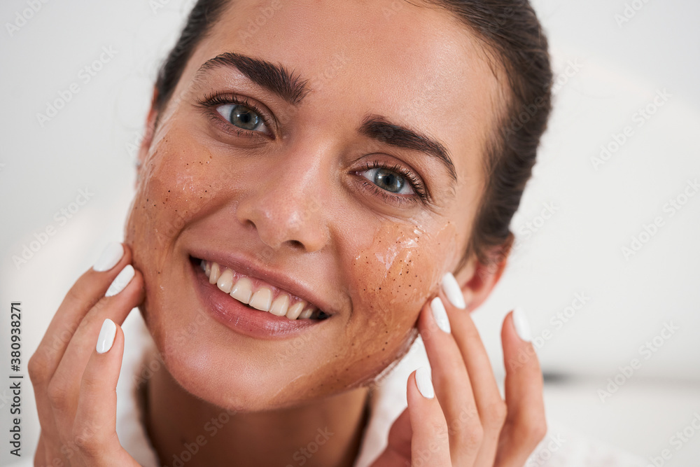 Woman applying cream to her face Woman applying cream to her face