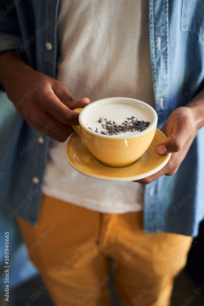 Waiter standing with cup of coffee Waiter standing with cup of coffee
