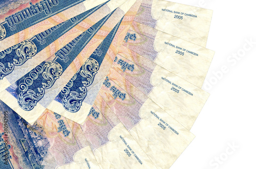 1000 Cambodian riels bills lies isolated on white background with copy space stacked in fan shape close up photo