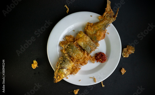 Bandeng Presto Goreng. Fried tendered-bone milkfish served with traditional side dishes photo