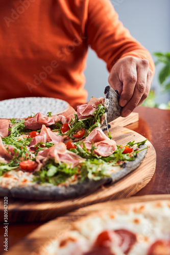 Fototapeta Naklejka Na Ścianę i Meble -  Cropped shot of Girl taking slice of pepperoni pizza
