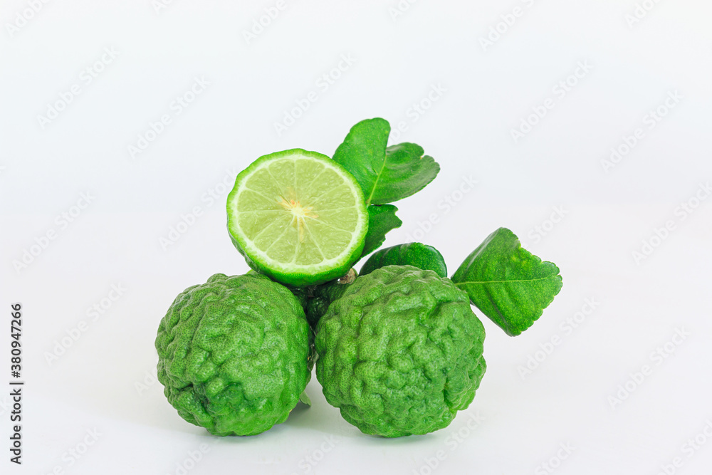 Green fresh bergamot fruit and cut half with leaf on white background. Green fresh bergamot fruit and cut half with leaf on white background.