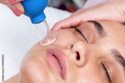 facial massage with cups in the spa salon