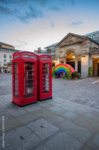 Red telephone box and rainbow in Covent Garden