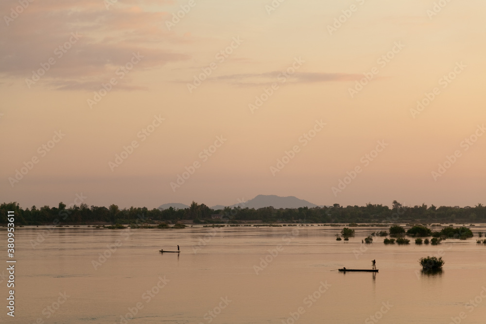 Muong Khong Laos 1/12/2012 Mekong river at dawn with golden sun and fishing boat