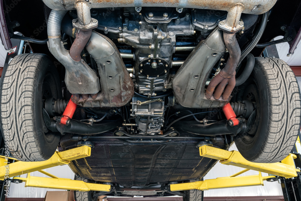 Undercarriage of fancy sports car show engineered design for speed and aerodynamics. Undercarriage of fancy sports car show engineered design for speed and aerodynamics.