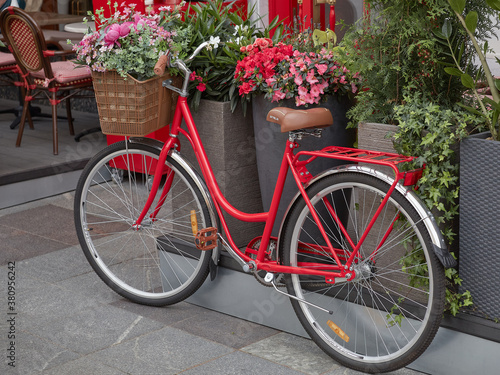 Vintage red bicycle with a basket of flowers