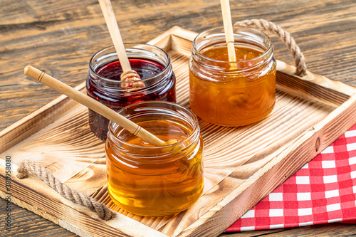 Various fruit marmalade jams in jars top view. Honey, apricot jam and strawberry jam in jars photo