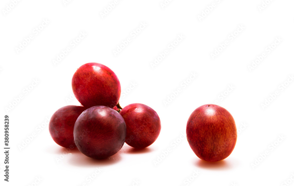 Close-up photo of red grapes several pieces on white isolated background