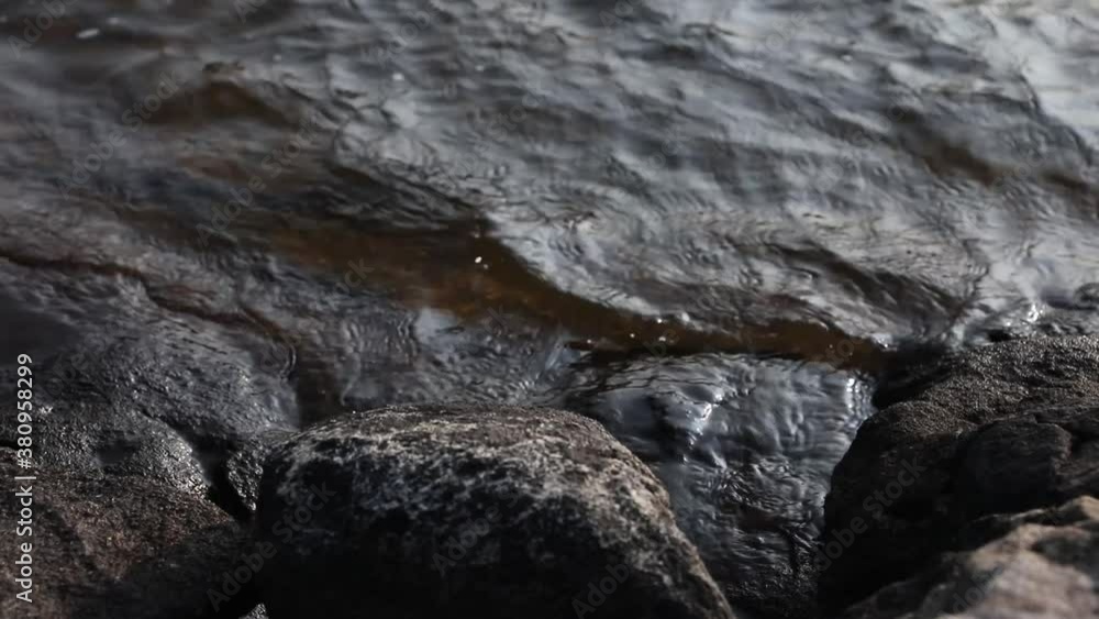 Lake water slowly lapping up on shore after a storm Lake water slowly lapping up on shore after a storm