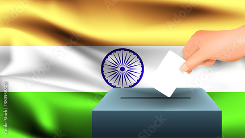 Male hand puts down a white sheet of paper with a mark as a symbol of a ballot paper against the background of the India flag. India the symbol of elections