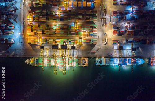 Container   container ship in export and import business and logistics. Shipping cargo to harbor by crane. Water transport International. Aerial view and top view.