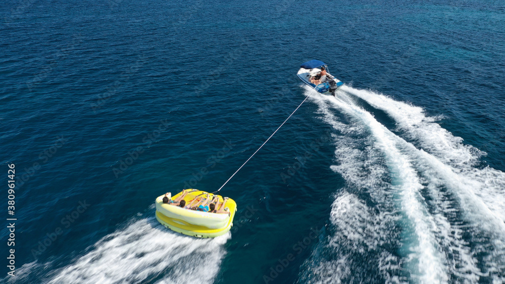 Aerial drone photo of extreme powerboat donut water-sports cruising in high speed in tropical exotic island bay Aerial drone photo of extreme powerboat donut water-sports cruising in high speed in tropical exotic island bay
