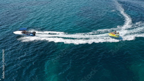 Aerial drone photo of extreme powerboat donut water-sports cruising in high speed in tropical exotic island bay © aerial-drone