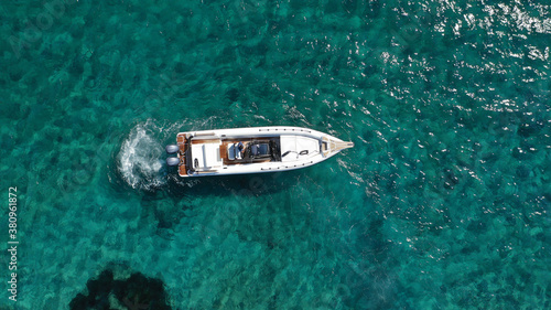 Aerial drone photo of luxury inflatable speed boat cruising in deep blue Aegean sea, Mykonos island, Cyclades, Greece © aerial-drone