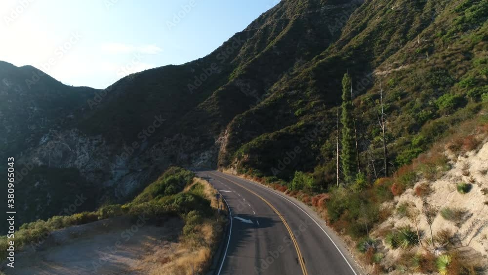 Drone flying towards a cool windy roadway in the mountians Drone flying towards a cool windy roadway in the mountians