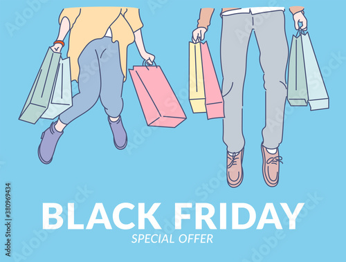 Black Friday banner concept. Young cheerful couple jumping with happiness on black friday from good shopping