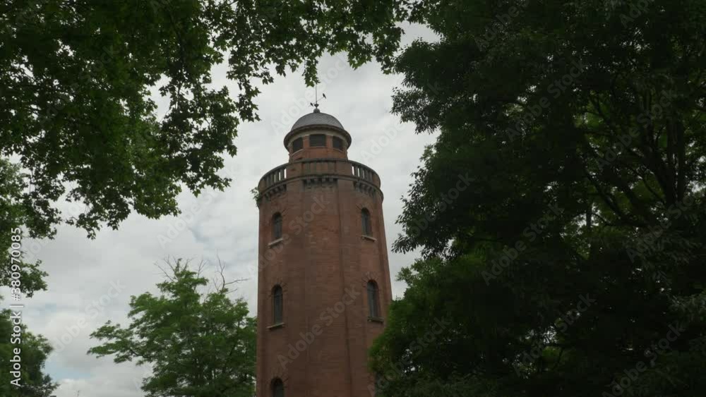 Slow Motion Approach around Tower in Toulouse with Foilage in the Foreground on a Cloudy day Slow Motion Approach around Tower in Toulouse with Foilage in the Foreground on a Cloudy day