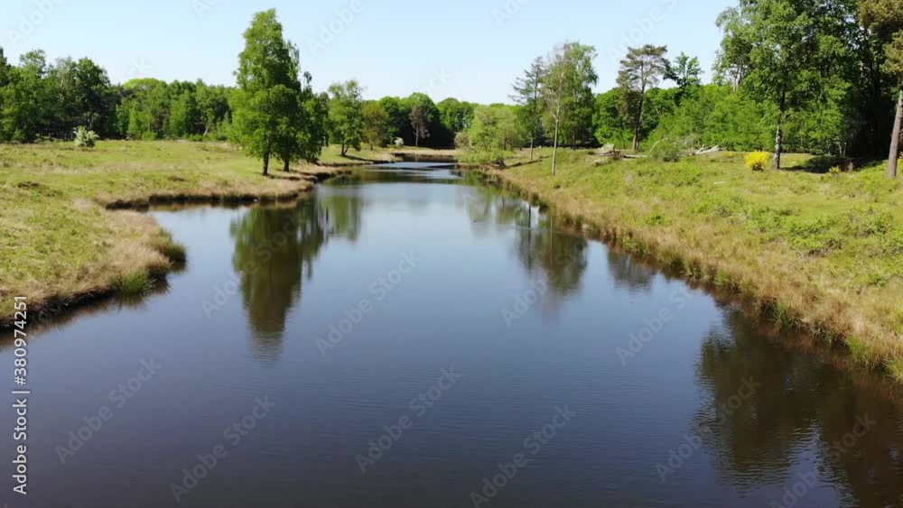 Drone shot over a slow moving stream in the Netherlands Drone shot over a slow moving stream in the Netherlands