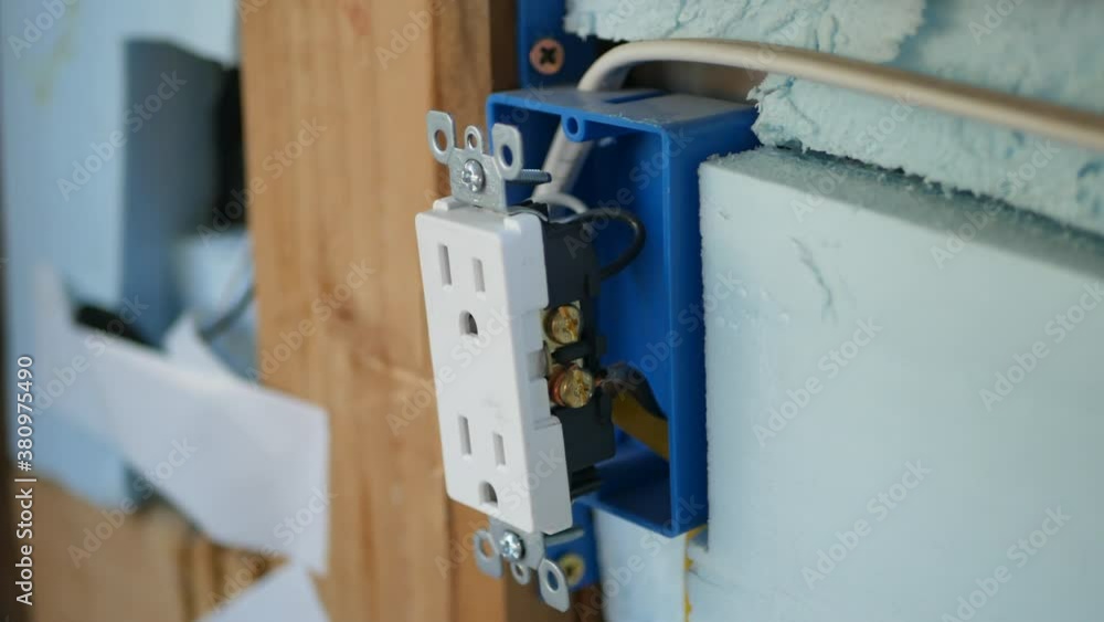 Electrical outlet being installed on diy construction site. Electrical outlet being installed on diy construction site.