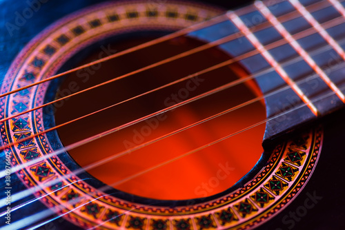 Details of an acoustic guitar, detailed photos of a guitar, guitar strings and soundhole, abstract, blurring, macrophoto