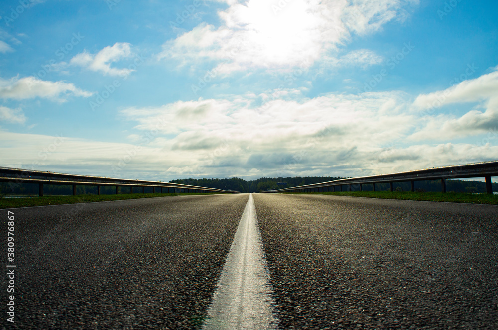 A beautiful automobile asphalt road without cars and people. A beautiful automobile asphalt road without cars and people.